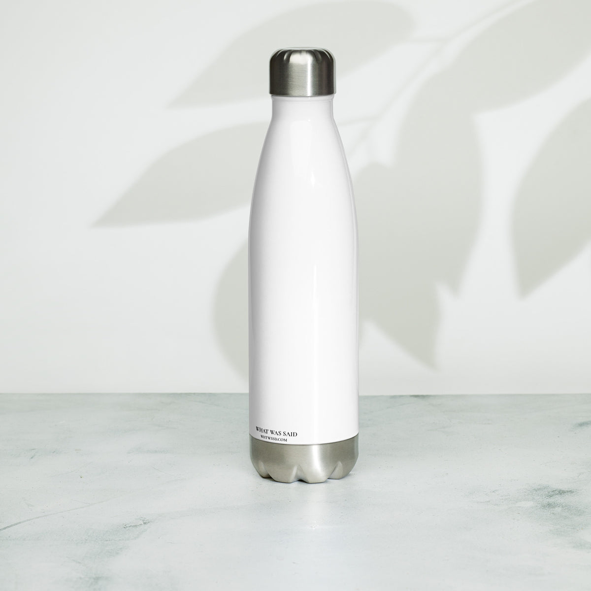 Back facing graphic water bottle in color white, against white background. Featuring brands website WHTWSSD.COM, in small black print on the back. From What Was Said (Statement Apparel + More).
