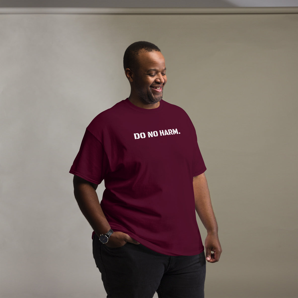 Model is wearing front facing graphic t-shirt in color maroon red, featuring statement 'DO NO HARM', in bold white print. From What Was Said (Statement Apparel + More).