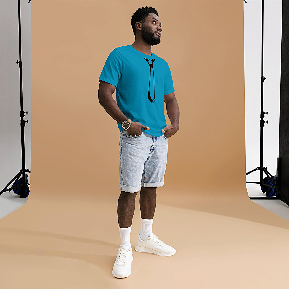 Model is wearing front-facing graphic T-shirt in color aqua blue, featuring printed image of men's neck tie, and the written word 'FORMAL', with a strike through it, in black print. From What Was Said (Statement Apparel + More). 