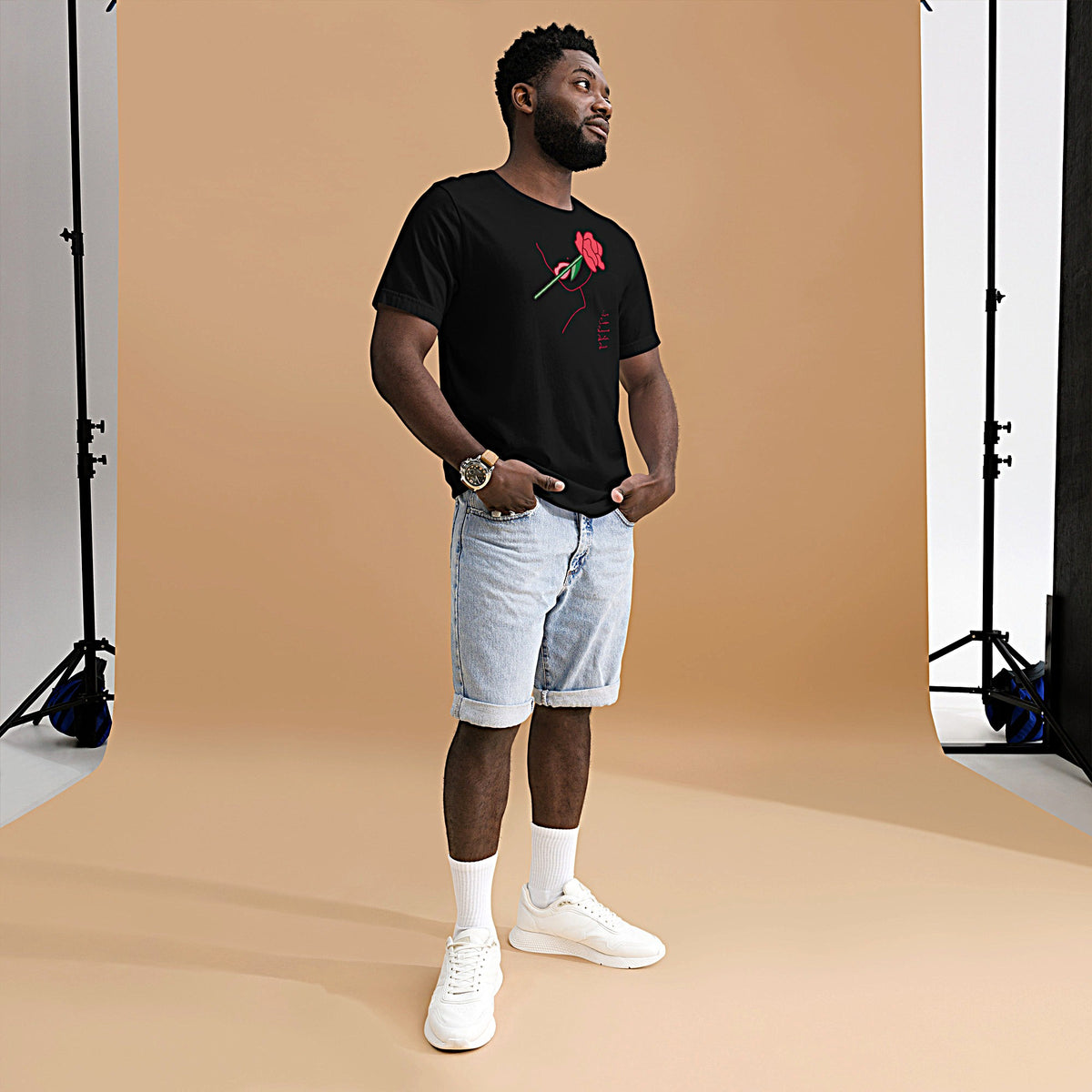 Model is wearing front-facing graphic T-shirt in color black, featuring a woman's profile outlined in red, with a rose in mouth and the words love, passion, romance, devotion, desire, in red print, from What Was Said (Statement Apparel + More).