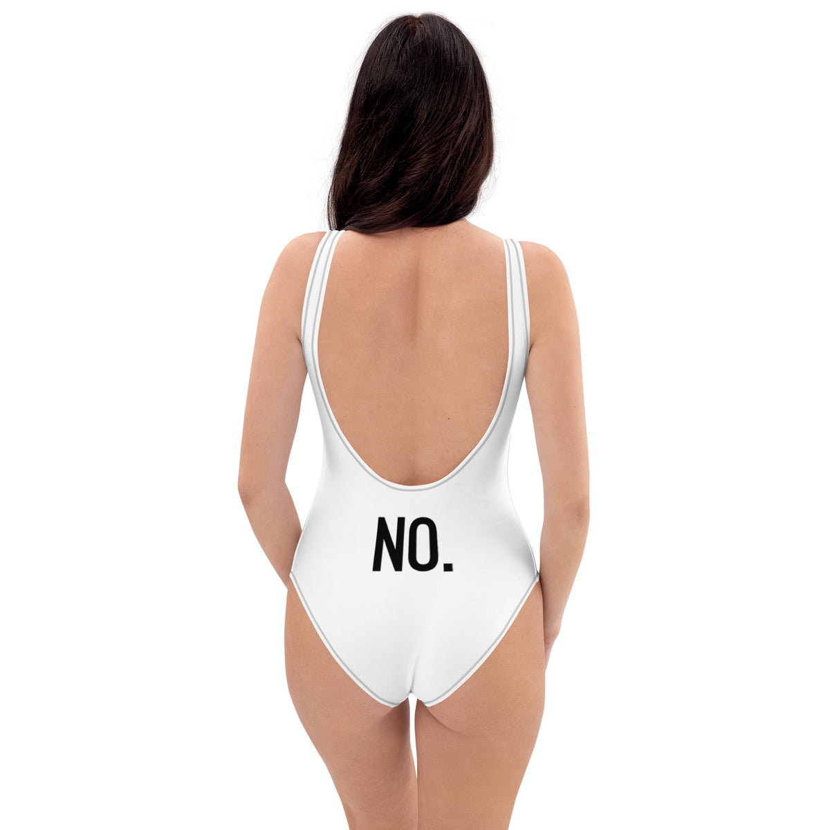 Model is wearing back facing adult graphic one-piece swimsuit in color white with black stitch trim, featuring the statement 'NO.' in bold black print. From What Was Said (Statement Apparel + More).