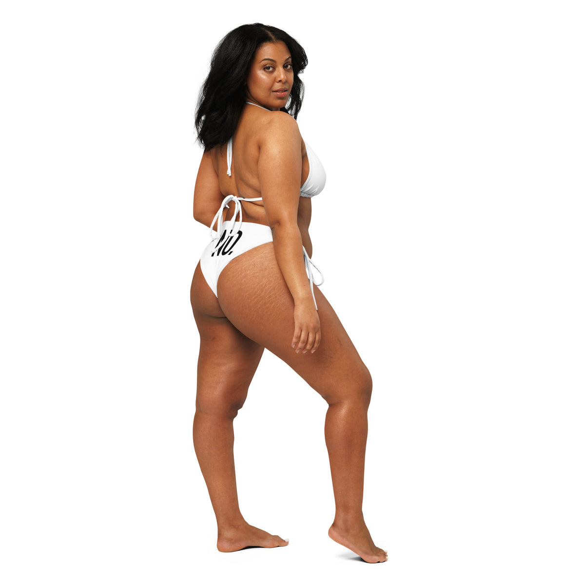 Model is wearing back facing graphic string bikini swimsuit in color white, featuring the statement 'NO.' in bold black print on the bikini back bottoms. From What Was Said (Statement Apparel + More).