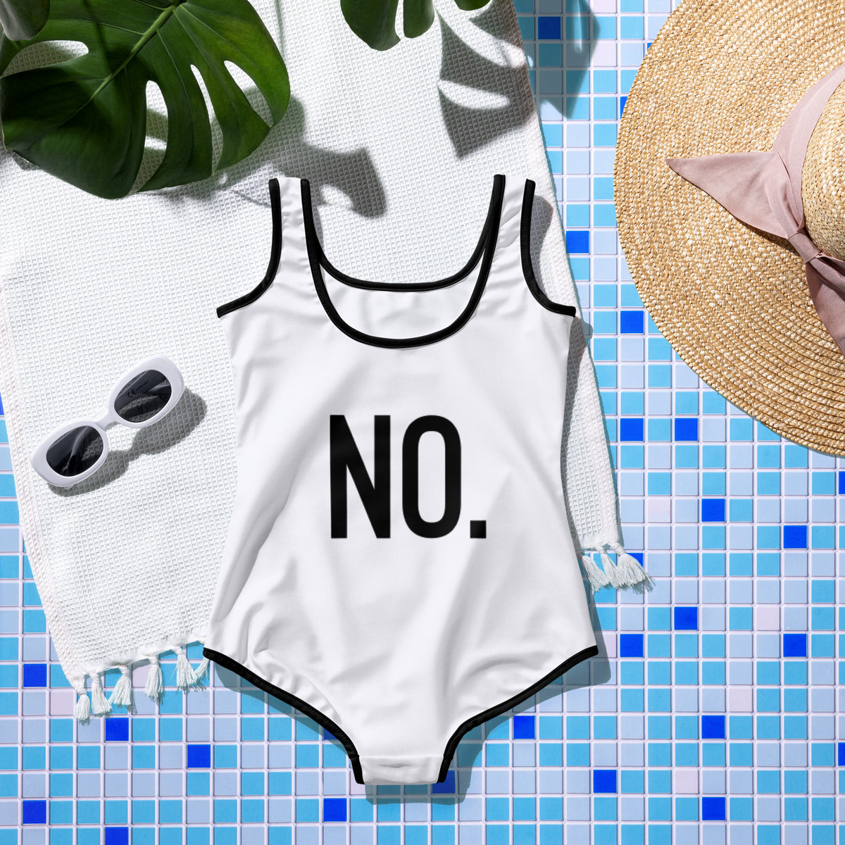 Back facing graphic youth one-piece swimsuit in color white with black trim, against a colorful background, featuring the statement 'NO.' in bold black print. From What Was Said (Statement Apparel + More).