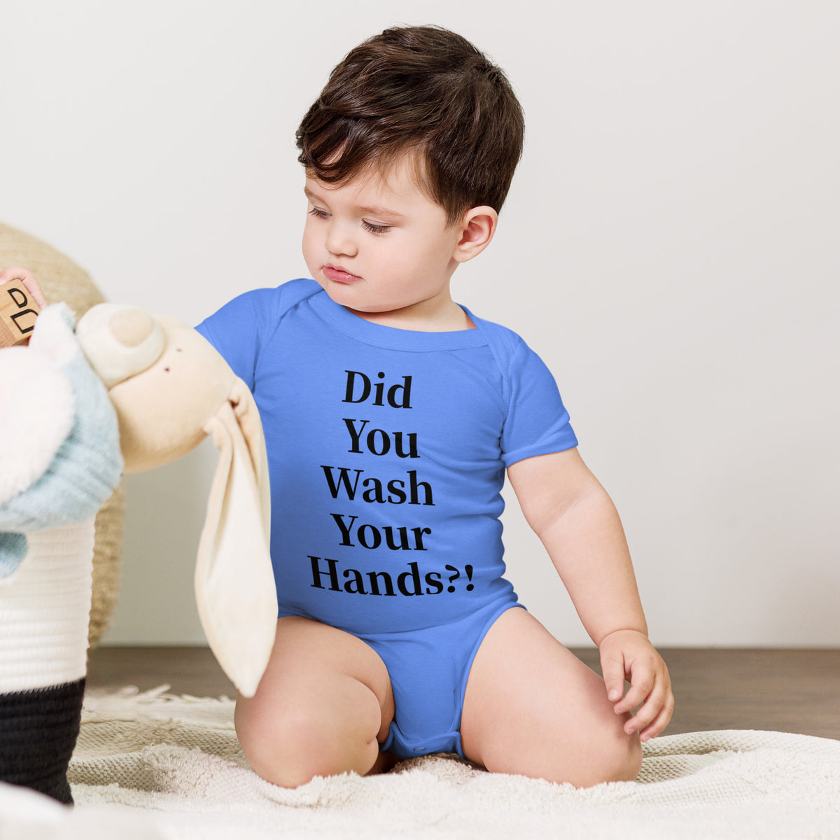 Model wearing front facing graphic onesie in color heather-columbia-blue, featuring statement, 'Did You Wash Your hands,' in black print. From What Was Said (Statement Apparel + More).