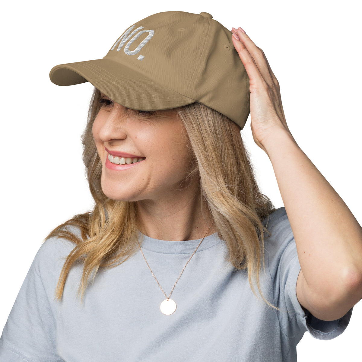 Model is wearing left front facing graphic dad hat in color khaki, featuring the statement 'NO.' in bold white embroidery. From What Was Said (Statement Apparel + More).