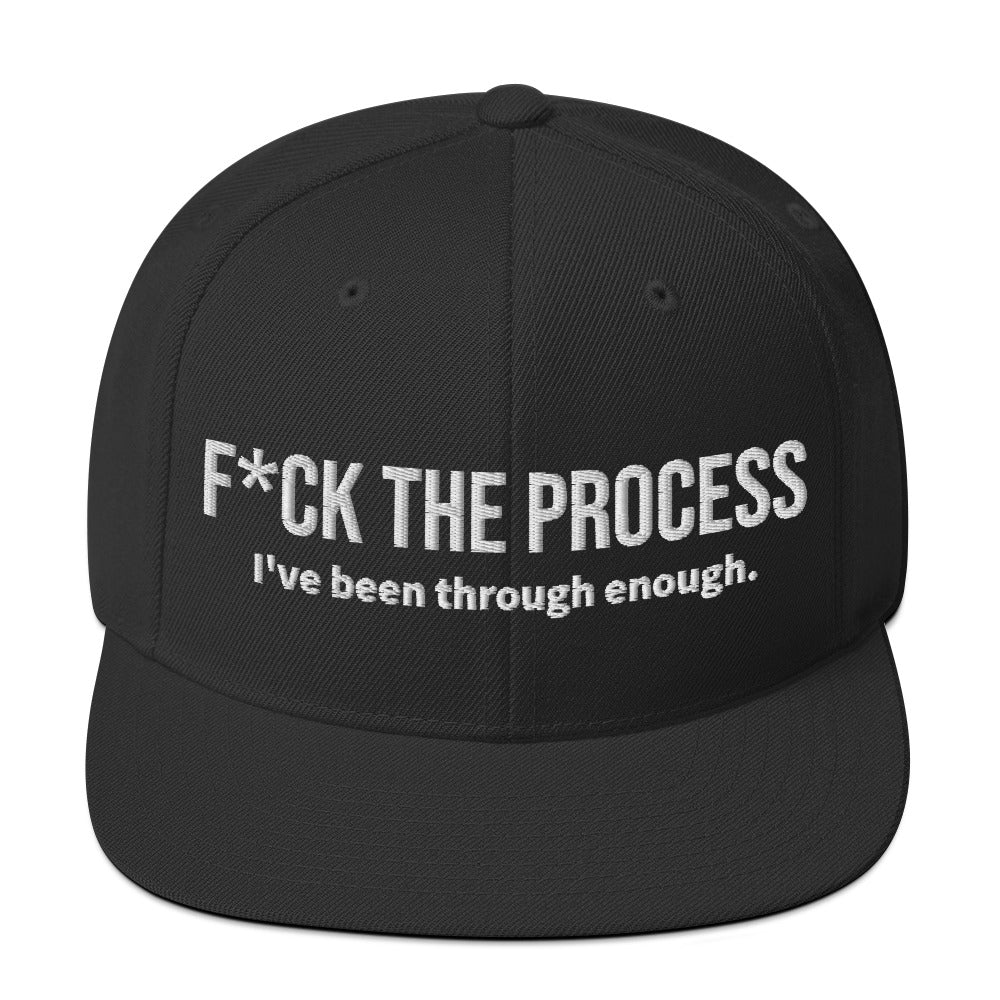 Front facing graphic snapback hat in color black, featuring the statement 'FUCK THE PROCESS, I've Been Through Enough,' in bold white embroidery. From What Was Said (Statement Apparel + More).