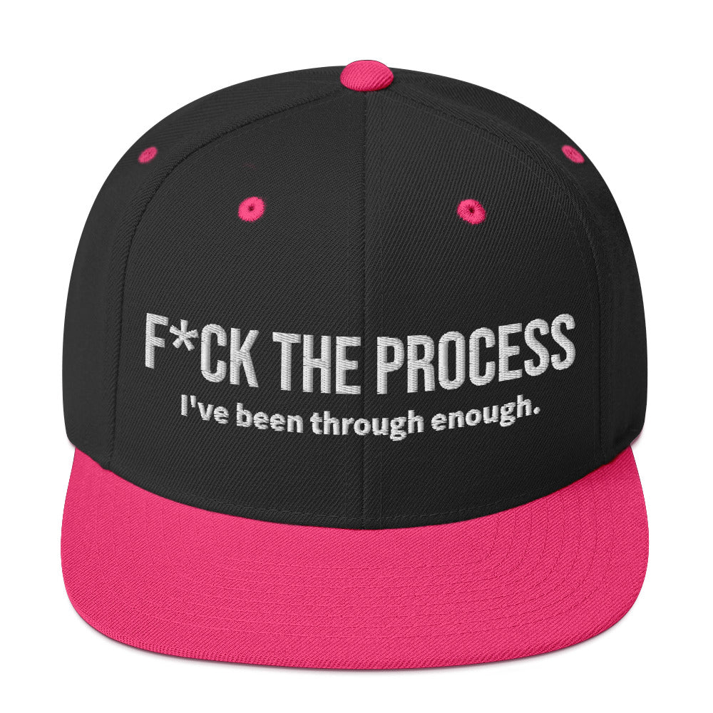 Front facing graphic snapback hat in color black and neon pink, featuring the statement 'FUCK THE PROCESS, I've Been Through Enough,' in bold white embroidery. From What Was Said (Statement Apparel + More).