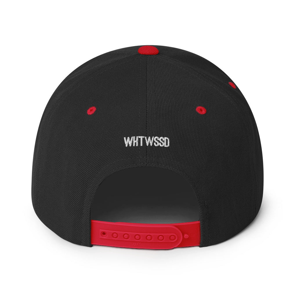 Product details on back facing graphic snapback hat in color black and red, featuring close up view of hats plastic snap closure and brand acronym WHTWSSD in white embroidery. From What Was Said (Statement Apparel + More).