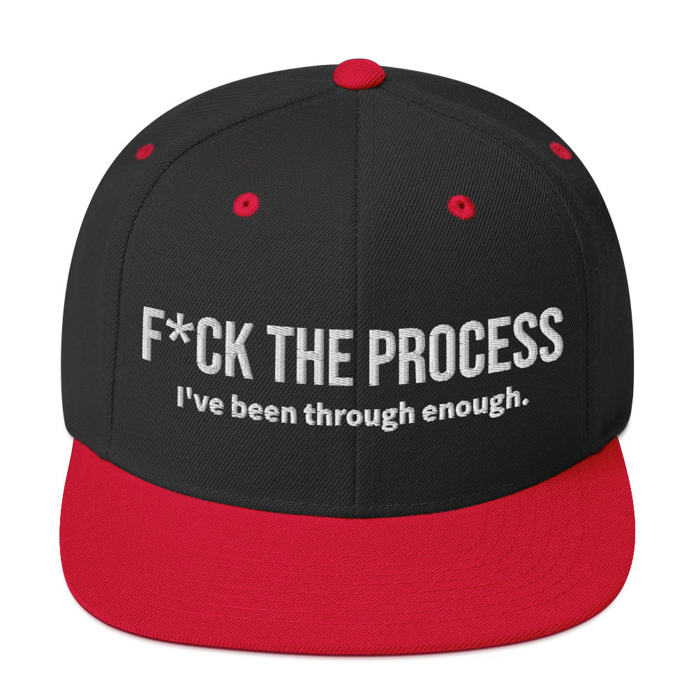 Front facing graphic snapback hat in color black and red, featuring the statement 'FUCK THE PROCESS, I've Been Through Enough,' in bold white embroidery. From What Was Said (Statement Apparel + More).