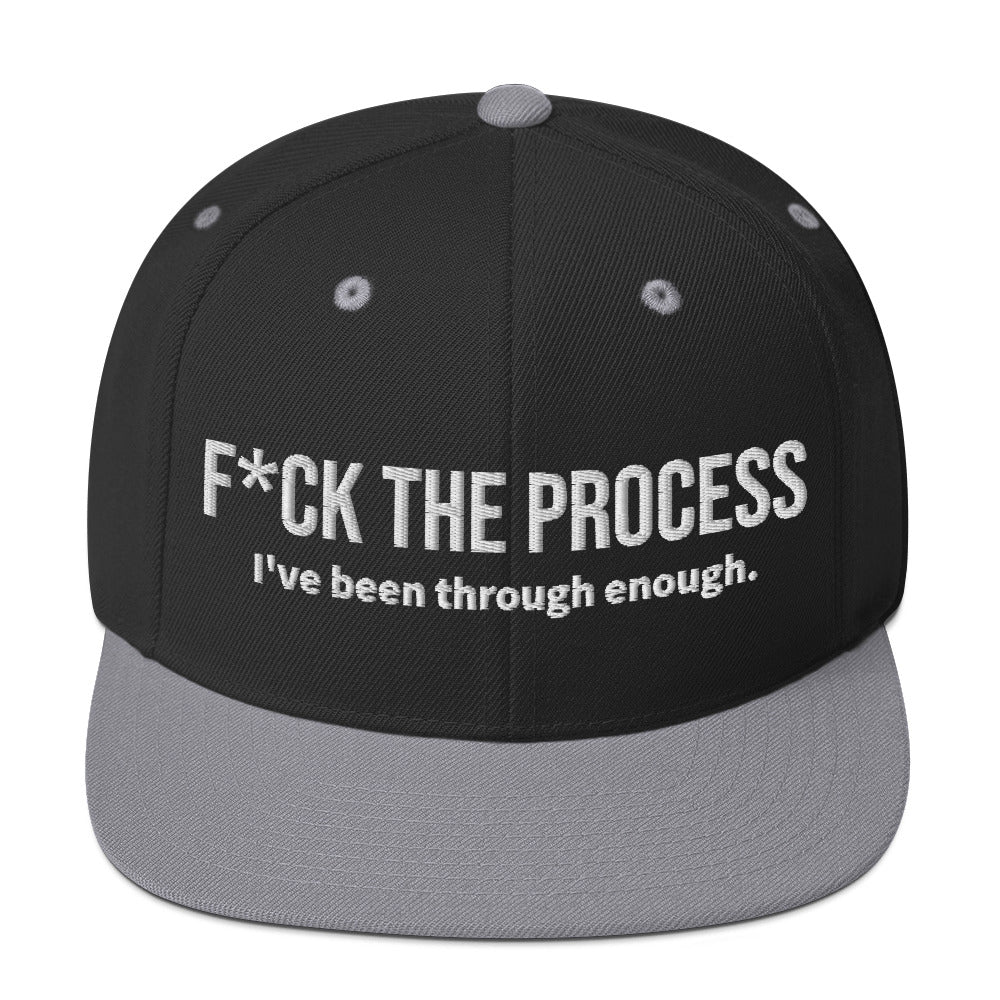 Front facing graphic snapback hat in color black and silver light grey, featuring the statement 'FUCK THE PROCESS, I've Been Through Enough,' in bold white embroidery. From What Was Said (Statement Apparel + More).
