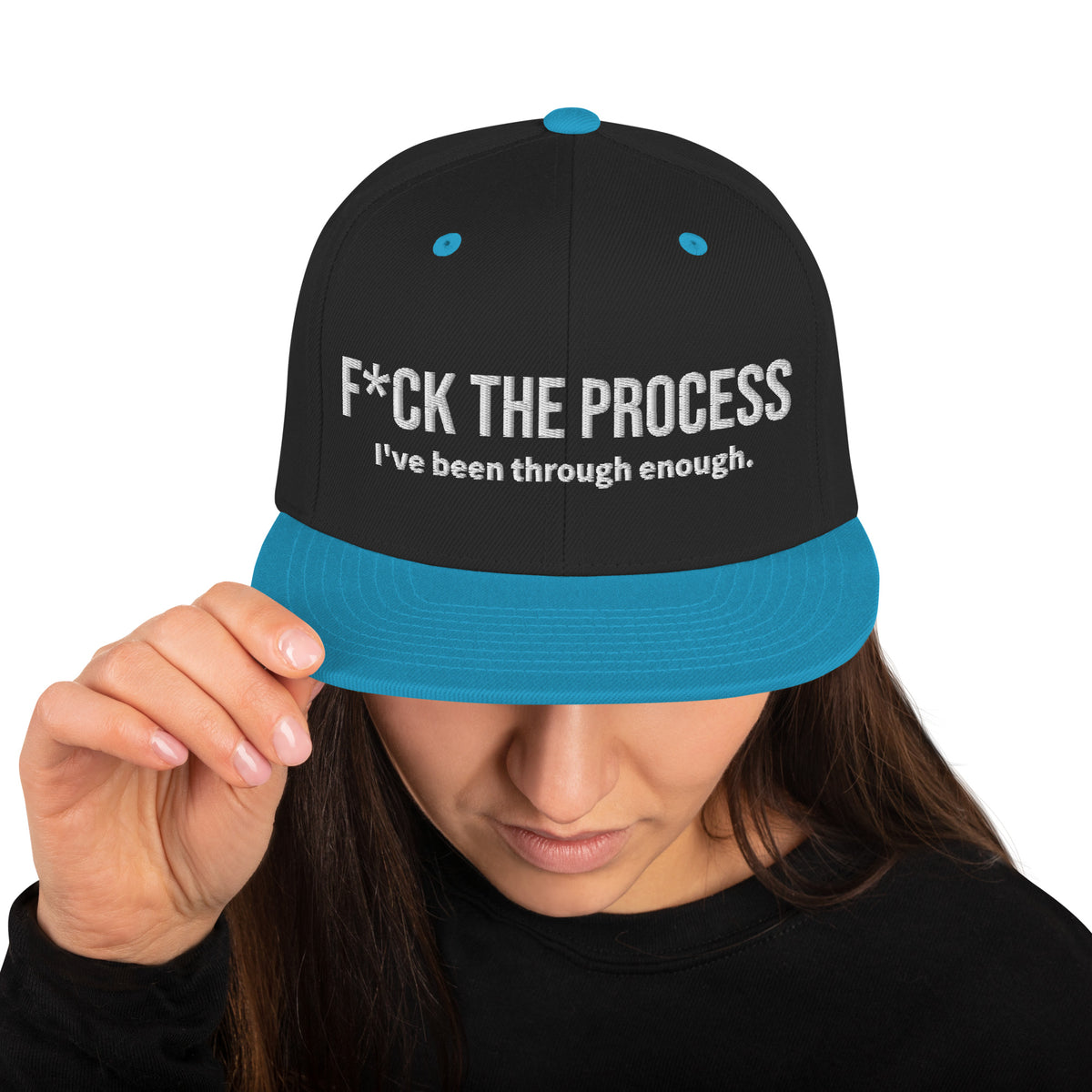 Model is wearing front facing graphic snapback hat in color black and teal, featuring the statement 'FUCK THE PROCESS, I've Been Through Enough,' in bold white embroidery. From What Was Said (Statement Apparel + More).