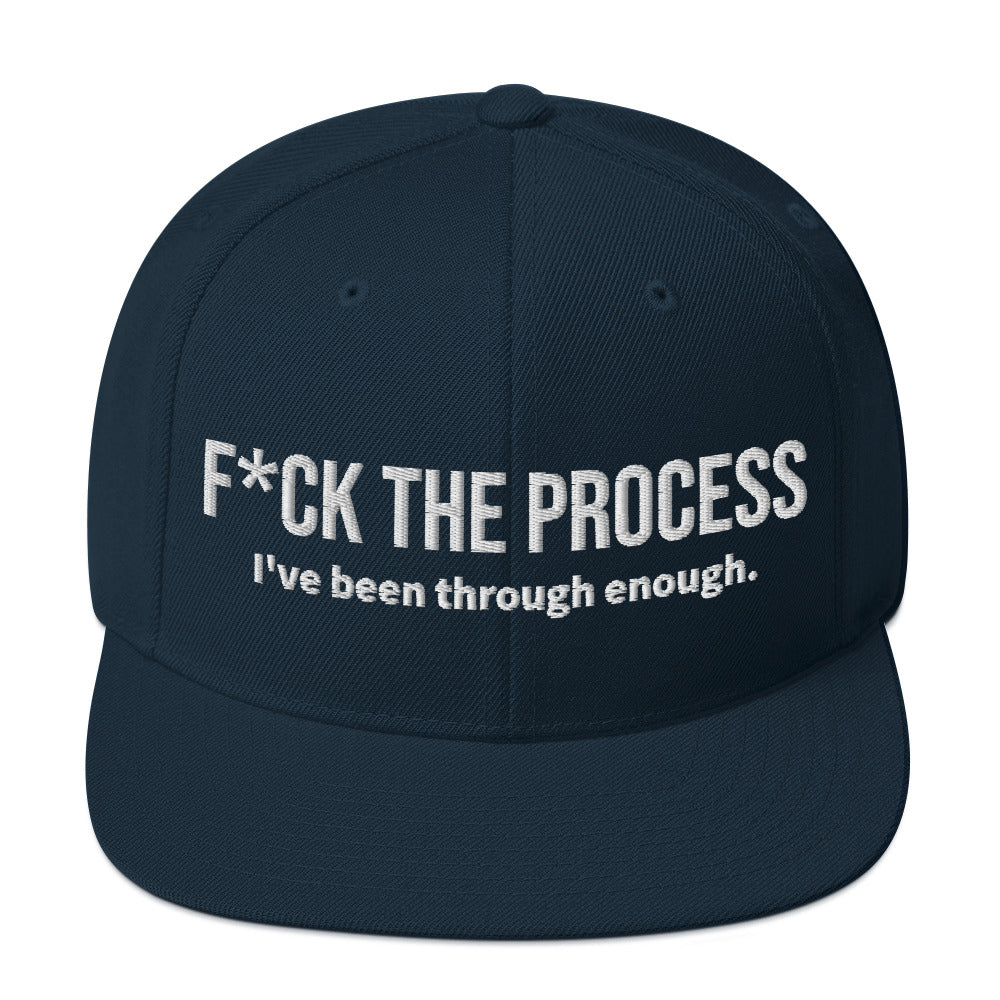 Front facing graphic snapback hat in color navy blue, featuring the statement 'FUCK THE PROCESS, I've Been Through Enough,' in bold white embroidery. From What Was Said (Statement Apparel + More).