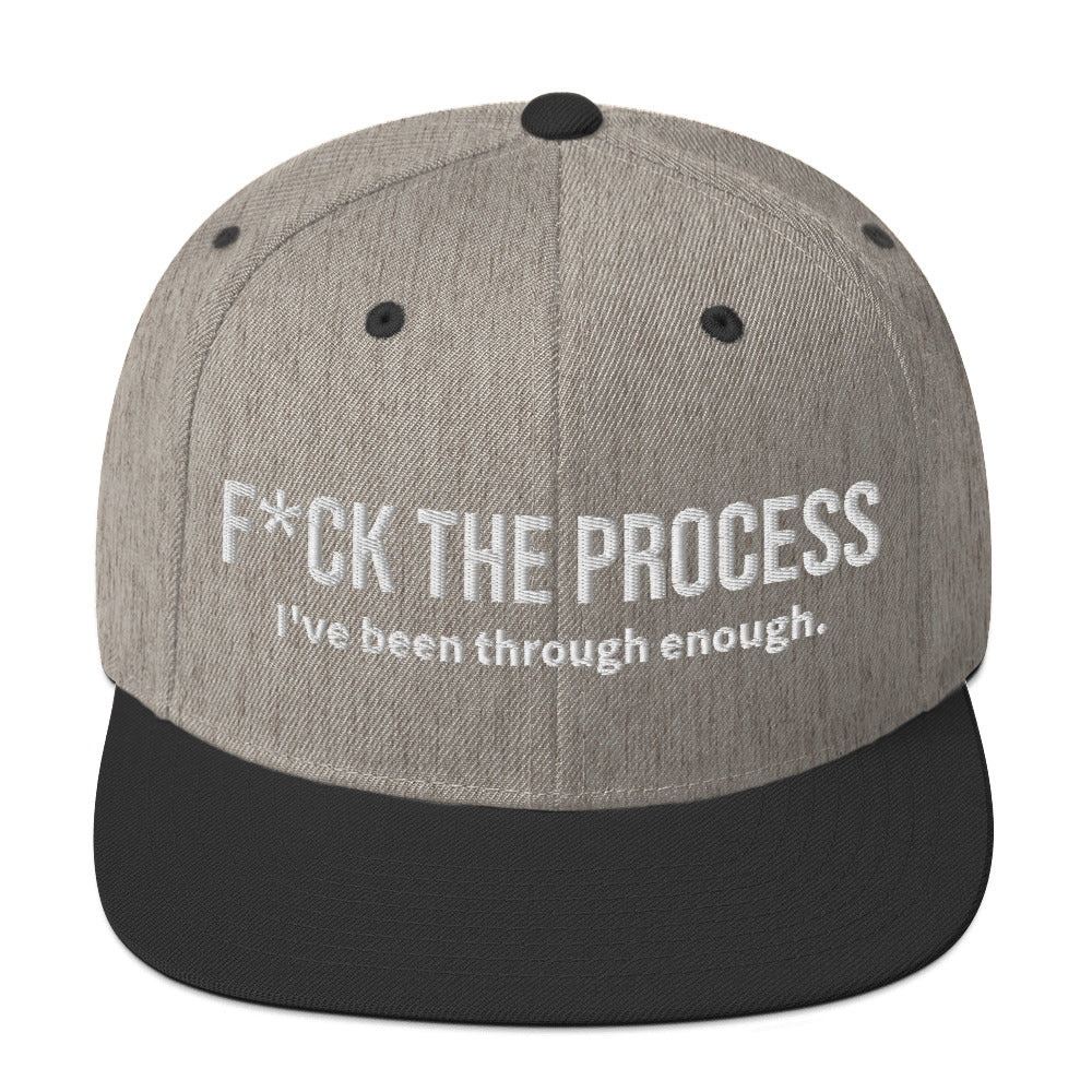 Front facing graphic snapback hat in color heather grey and black, featuring the statement 'FUCK THE PROCESS, I've Been Through Enough,' in bold white embroidery. From What Was Said (Statement Apparel + More).