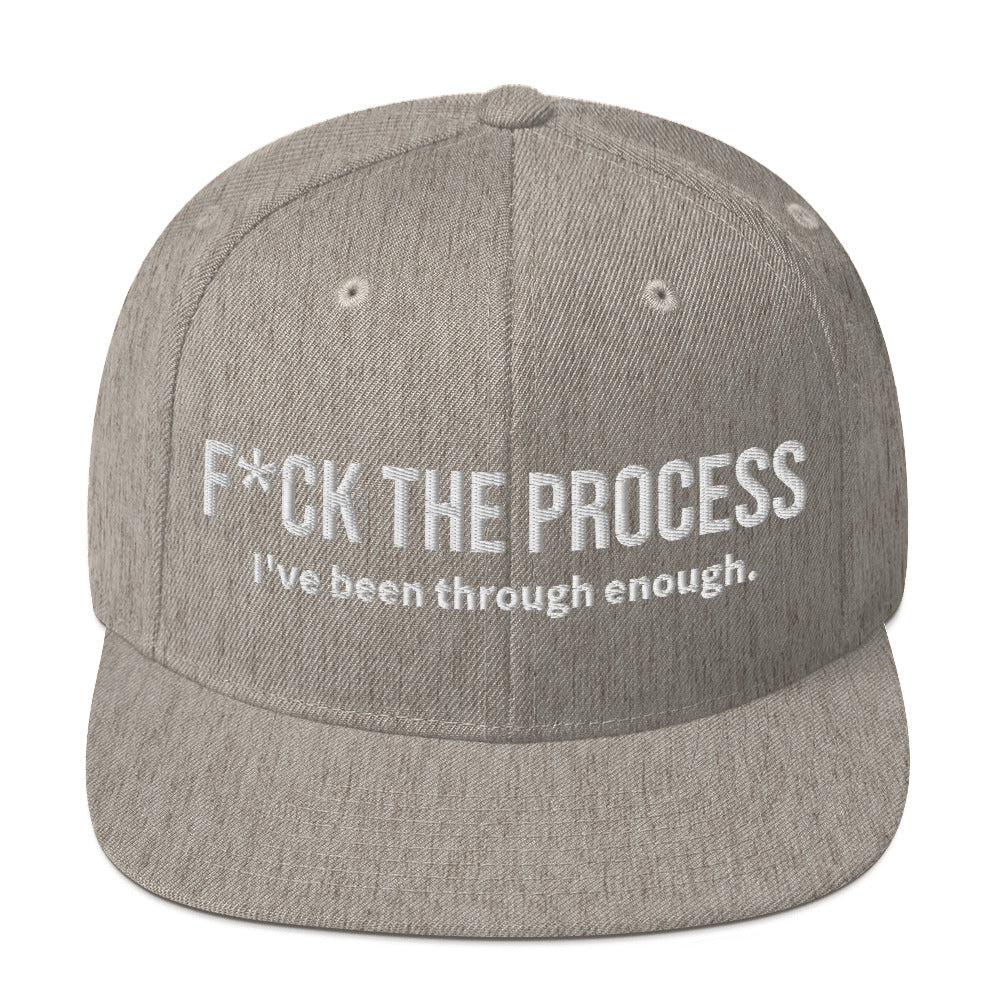 Front facing graphic snapback hat in color heather grey, featuring the statement 'FUCK THE PROCESS, I've Been Through Enough,' in bold white embroidery. From What Was Said (Statement Apparel + More).