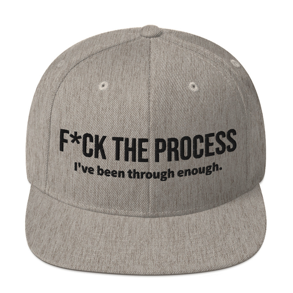 Front facing graphic snapback hat in color heather grey, featuring the statement 'FUCK THE PROCESS, I've Been Through Enough,' in bold black embroidery. From What Was Said (Statement Apparel + More).