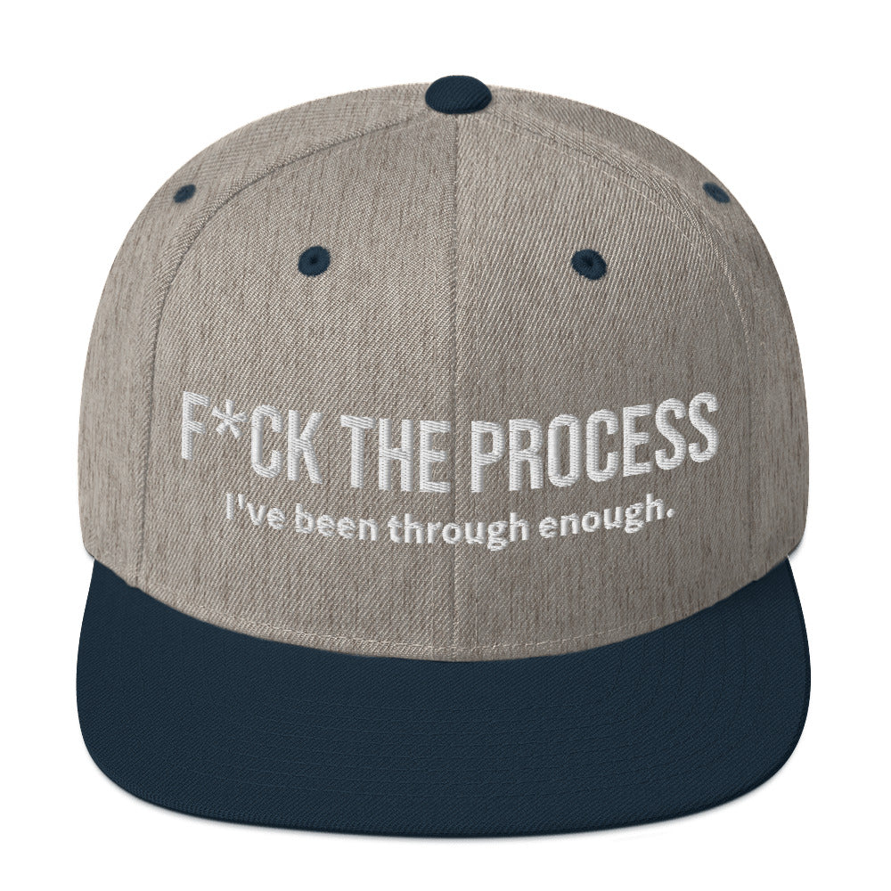 Front facing graphic snapback hat in color heather grey and navy, featuring the statement 'FUCK THE PROCESS, I've Been Through Enough,' in bold white embroidery. From What Was Said (Statement Apparel + More).