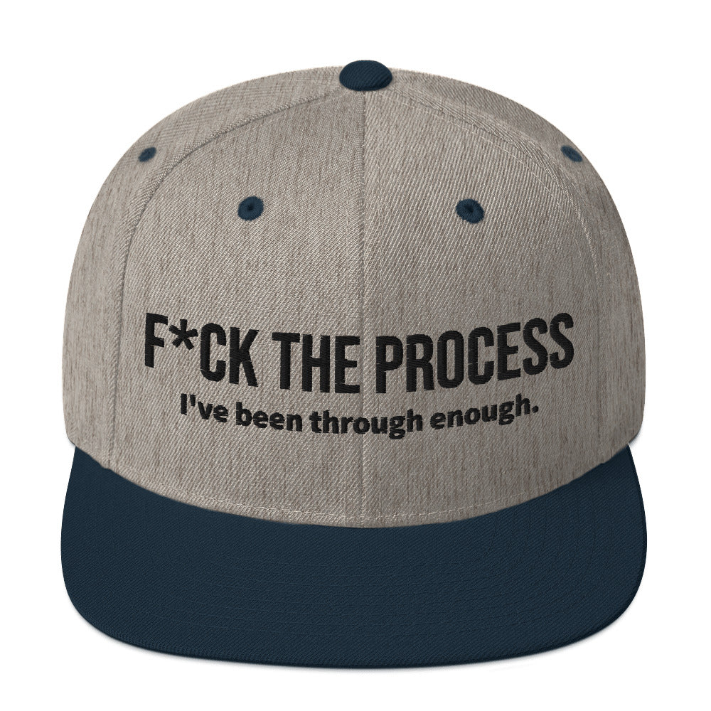 Front facing graphic snapback hat in color heather grey and navy, featuring the statement 'FUCK THE PROCESS, I've Been Through Enough,' in bold black embroidery. From What Was Said (Statement Apparel + More).