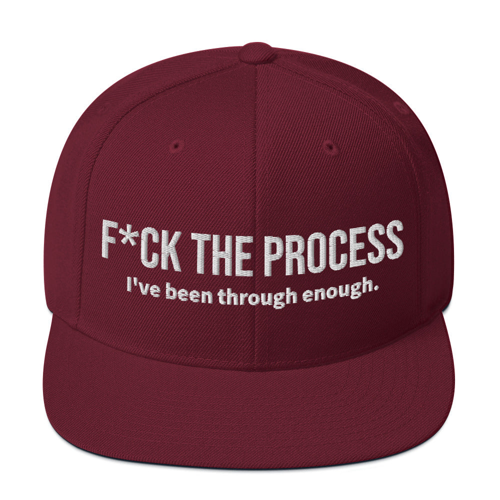 Front facing graphic snapback hat in color maroon red, featuring the statement 'FUCK THE PROCESS, I've Been Through Enough,' in bold white embroidery. From What Was Said (Statement Apparel + More).