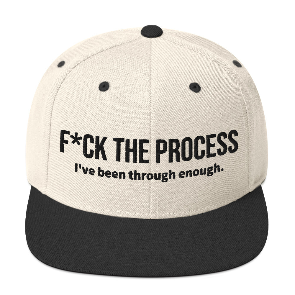 Front facing graphic snapback hat in color natural and black, featuring the statement 'FUCK THE PROCESS, I've Been Through Enough,' in bold black embroidery. From What Was Said (Statement Apparel + More).