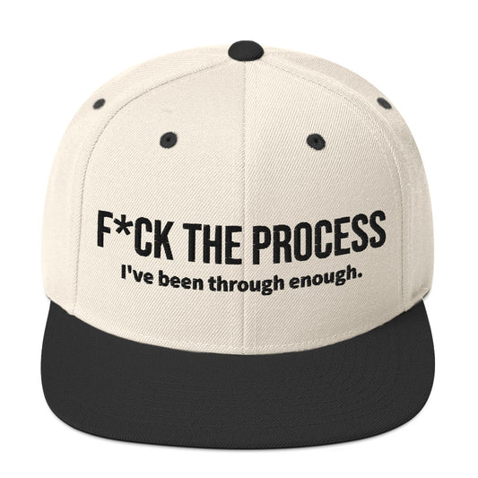 Front facing graphic snapback hat in color natural and black, featuring the statement 'FUCK THE PROCESS, I've Been Through Enough,' in bold black embroidery. From What Was Said (Statement Apparel + More).