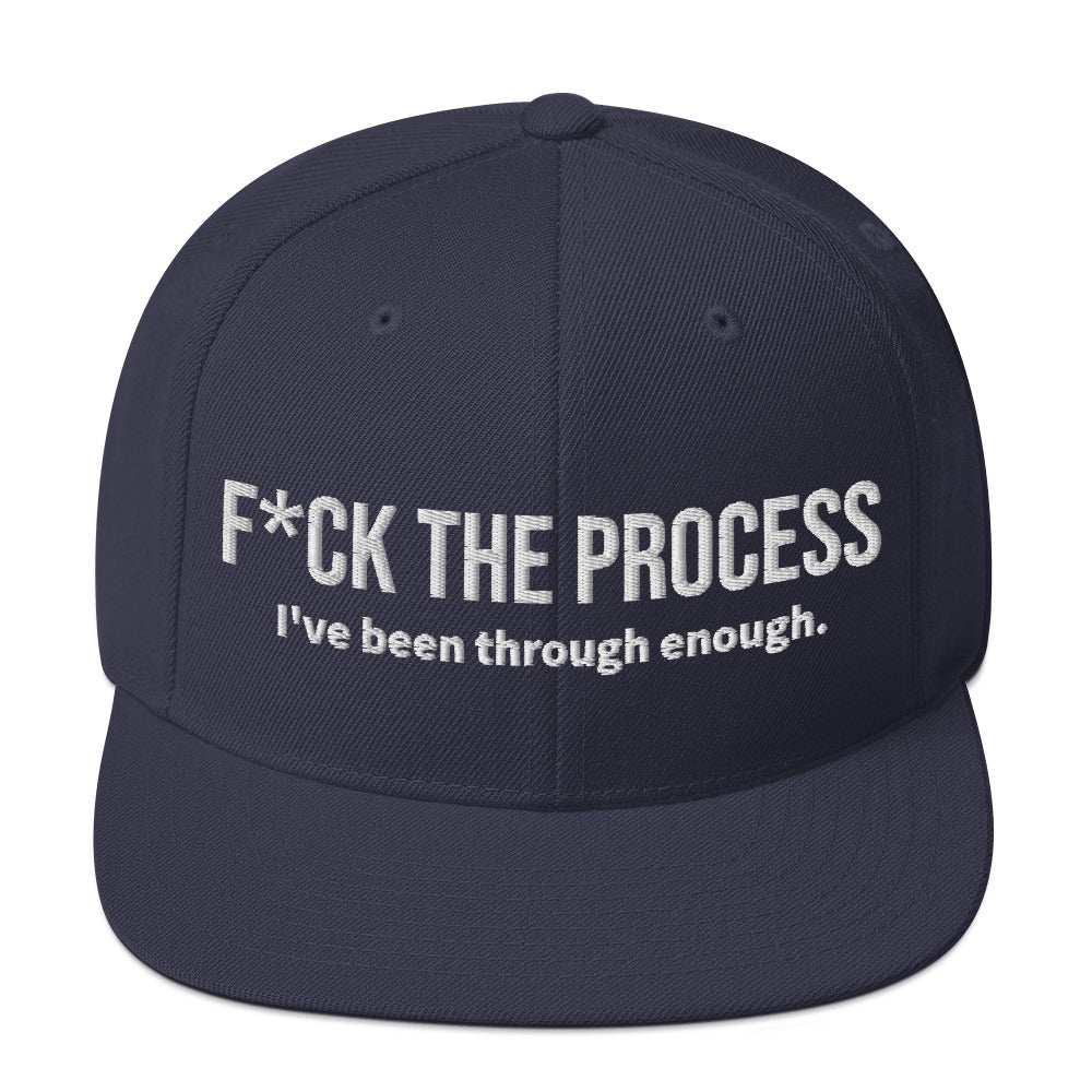 Front facing graphic snapback hat in color navy blue, featuring the statement 'FUCK THE PROCESS, I've Been Through Enough,' in bold white embroidery. From What Was Said (Statement Apparel + More).