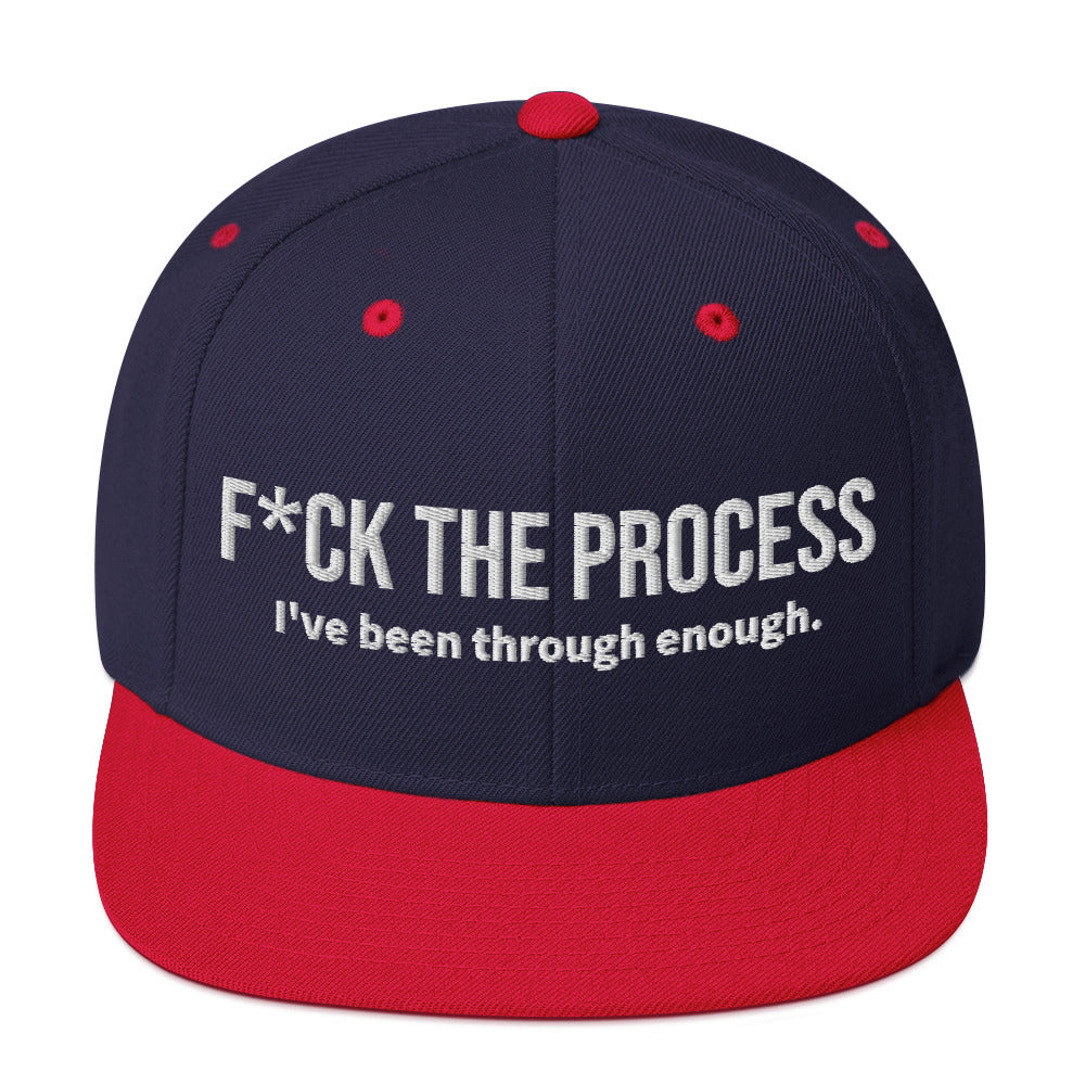 Front facing graphic snapback hat in color navy blue and red, featuring the statement 'FUCK THE PROCESS, I've Been Through Enough,' in bold white embroidery. From What Was Said (Statement Apparel + More).