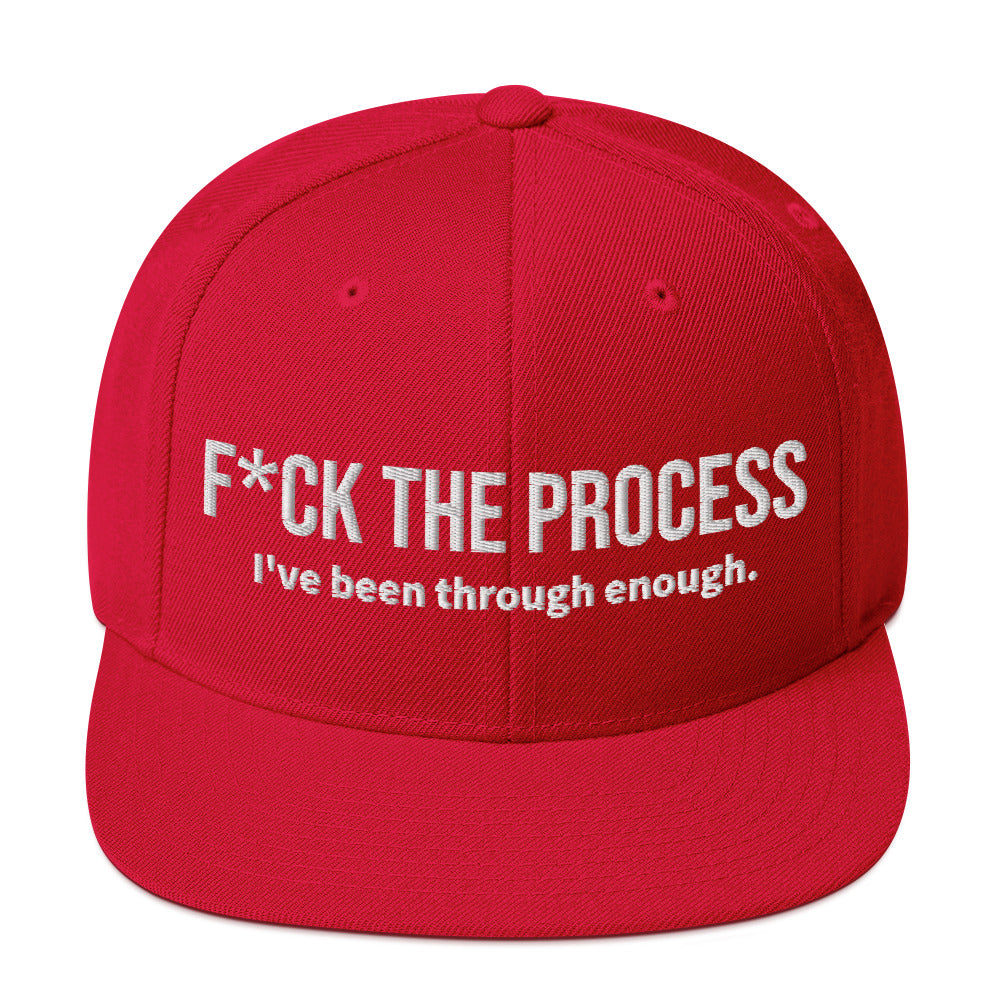 Front facing graphic snapback hat in color red, featuring the statement 'FUCK THE PROCESS, I've Been Through Enough,' in bold white embroidery. From What Was Said (Statement Apparel + More).