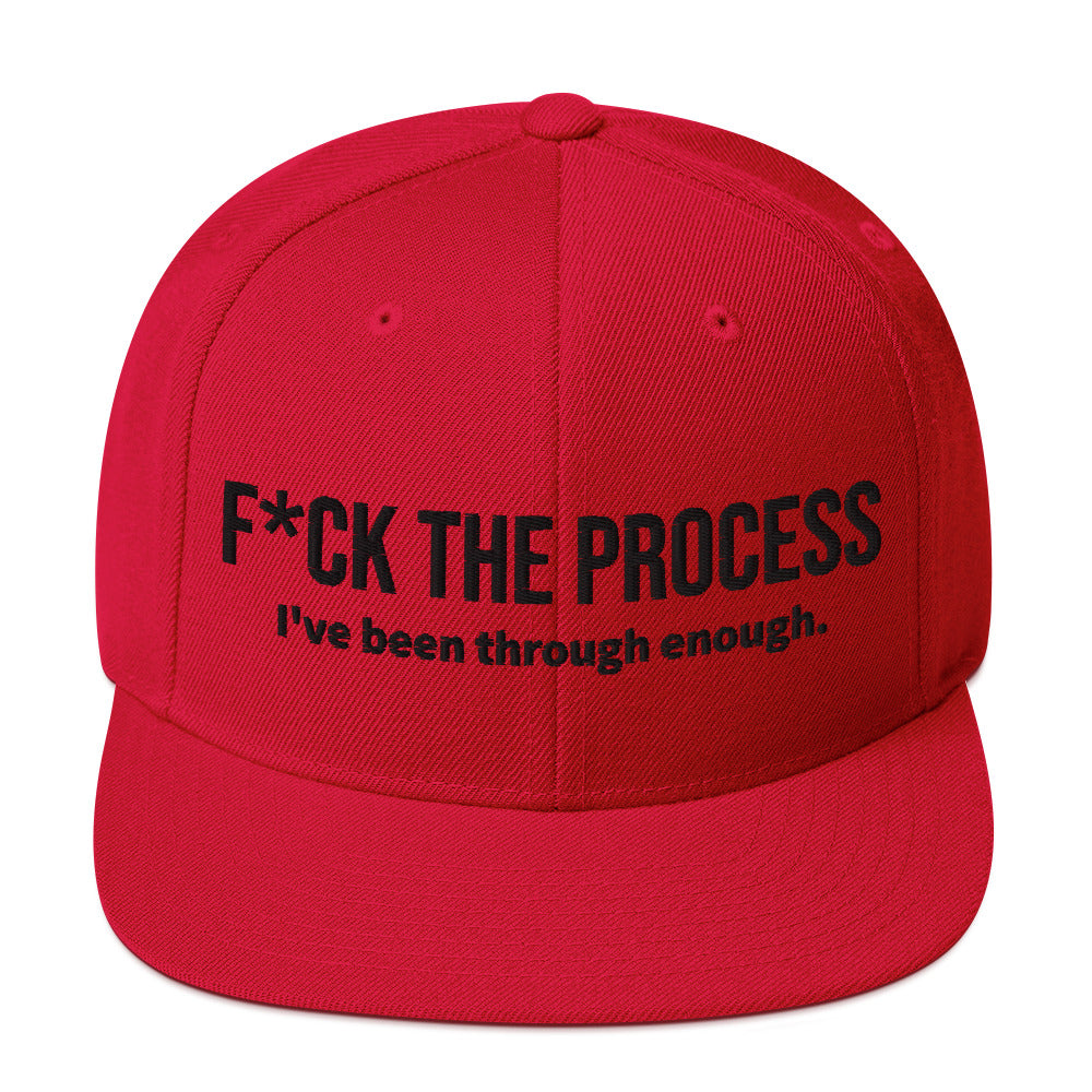 Front facing graphic snapback hat in color red, featuring the statement 'FUCK THE PROCESS, I've Been Through Enough,' in bold black embroidery. From What Was Said (Statement Apparel + More).