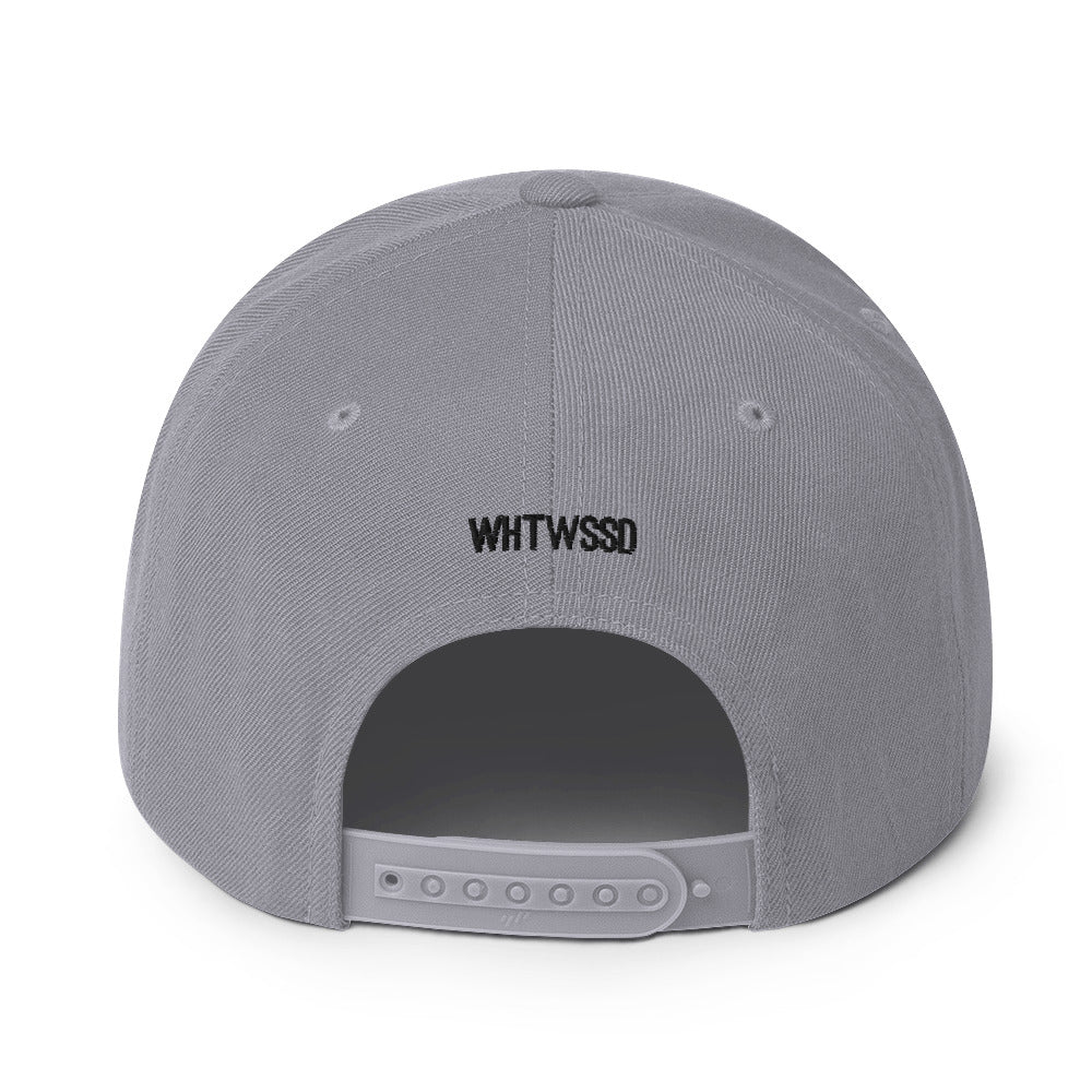 Product details on back facing graphic snapback hat in color silver light grey, featuring close up view of hats plastic snap closure and brand acronym WHTWSSD in black embroidery. From What Was Said (Statement Apparel + More).