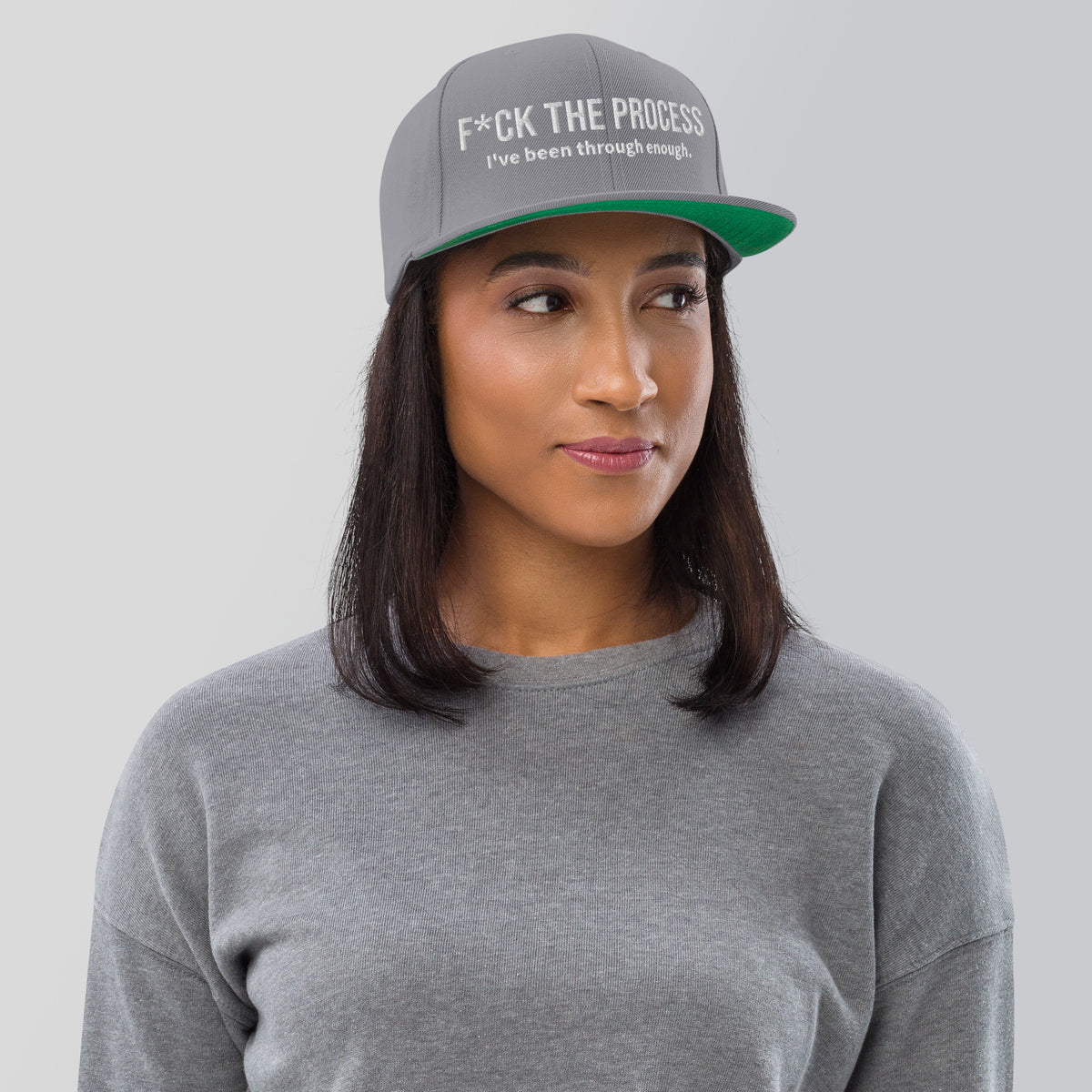 Model is wearing front facing graphic snapback hat in color silver light grey, featuring the statement 'FUCK THE PROCESS, I've Been Through Enough,' in bold white embroidery. From What Was Said (Statement Apparel + More).