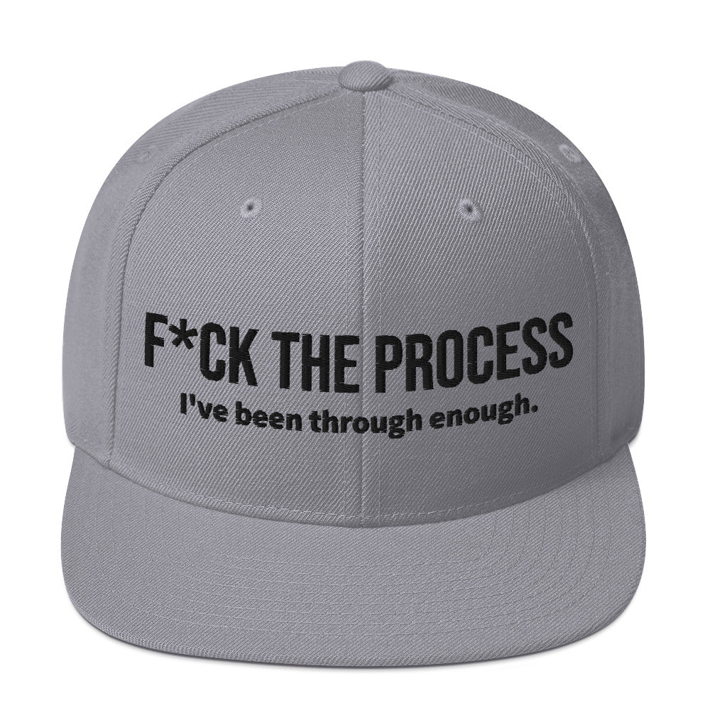 Front facing graphic snapback hat in color silver light grey, featuring the statement 'FUCK THE PROCESS, I've Been Through Enough,' in bold black embroidery. From What Was Said (Statement Apparel + More).