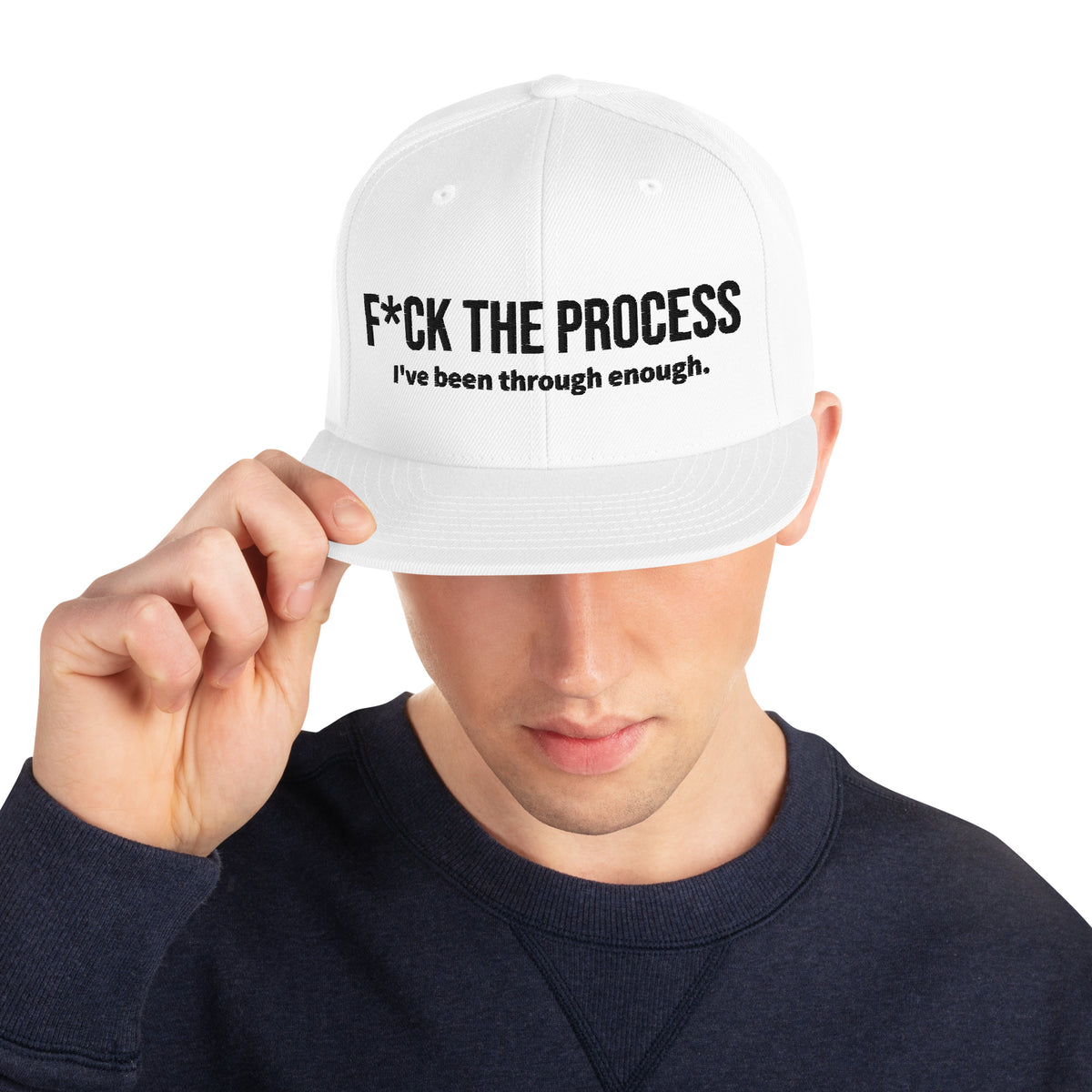 Model is wearing front facing graphic snapback hat in color white, featuring the statement 'FUCK THE PROCESS, I've Been Through Enough,' in bold black embroidery. From What Was Said (Statement Apparel + More).