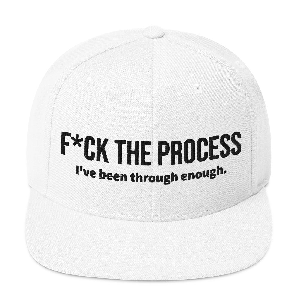 Front facing graphic snapback hat in color white, featuring the statement 'FUCK THE PROCESS, I've Been Through Enough,' in bold black embroidery. From What Was Said (Statement Apparel + More).
