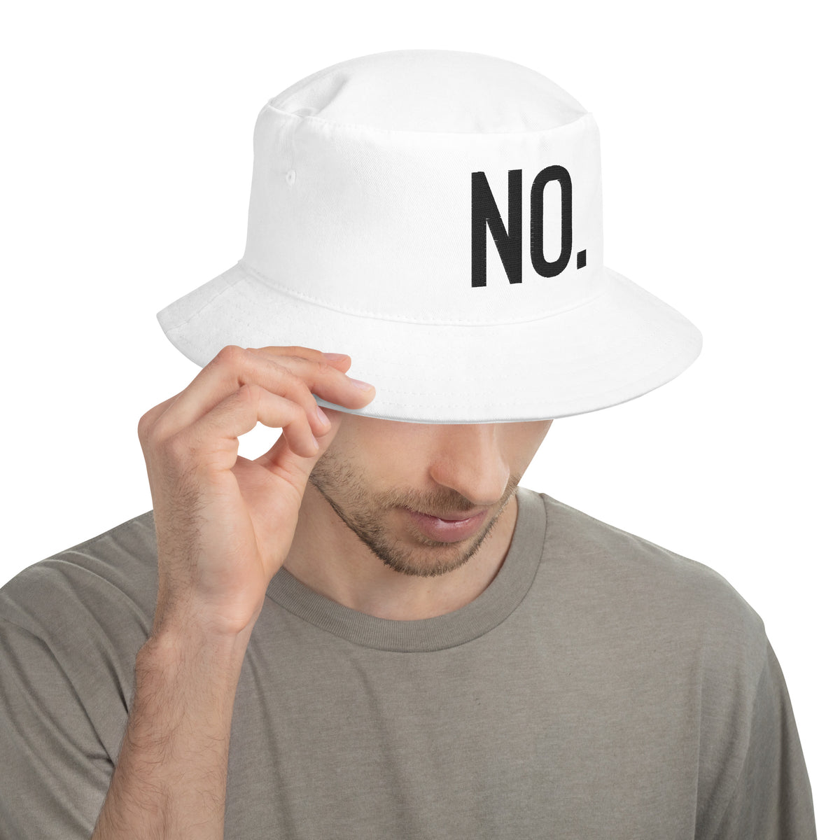 Model wearing front facing graphic bucket hat in color white, featuring the statement 'NO.' in bold black embroidery. From What Was Said (Statement Apparel + More).