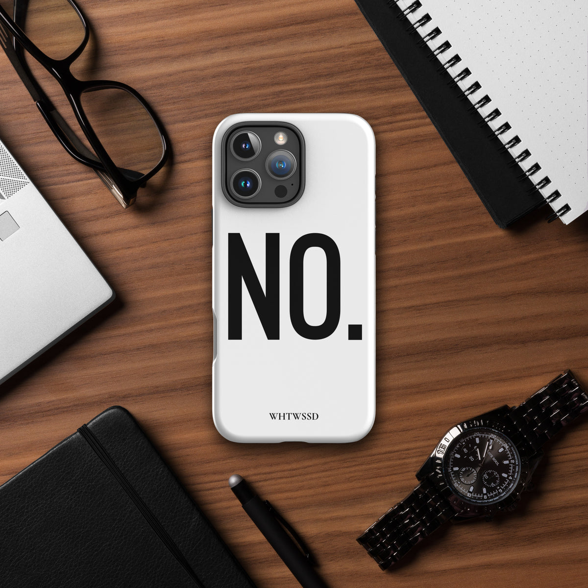 Front facing graphic iPhone 16 Pro Max case in color white, on desk background. Featuring the statement 'NO.' in bold black print on the phone case. From What Was Said (Statement Apparel + More). 