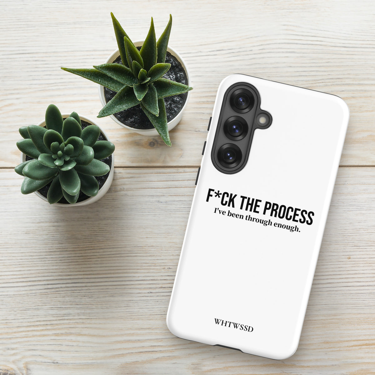 Front facing graphic Samsung Galaxy S25 Plus case, against white desk background. Featuring the statement 'F*CK THE PROCESS, I've been through enough.' in bold black print on the phone case. From What Was Said (Statement Apparel + More). 