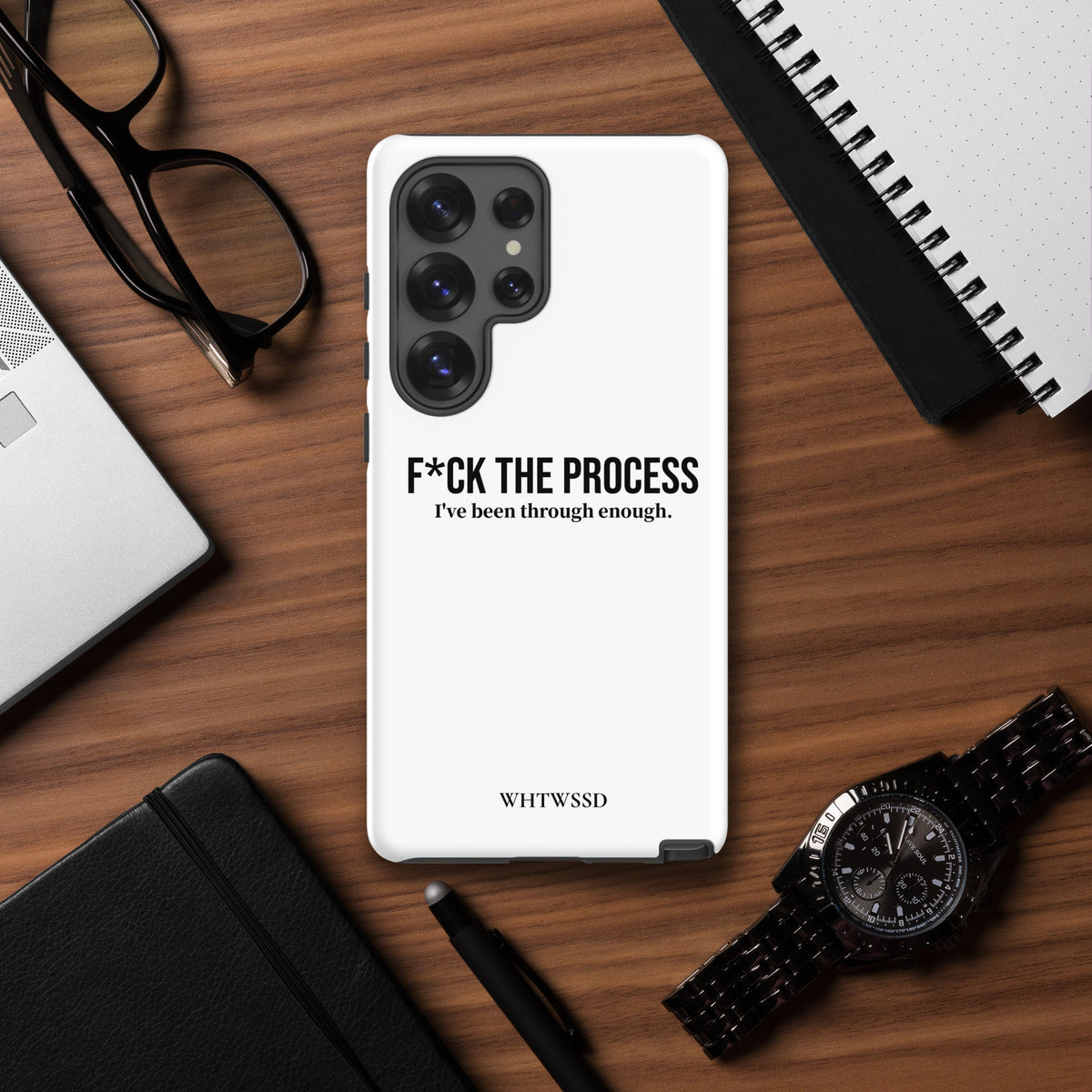 Front facing graphic Samsung Galaxy S25 Ultra case, against desk background. Featuring the statement 'F*CK THE PROCESS, I've been through enough.' in bold black print on the phone case. From What Was Said (Statement Apparel + More). 