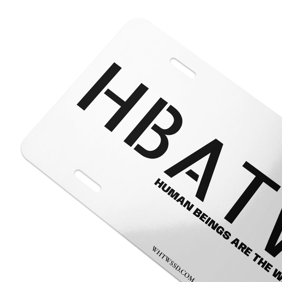 Front facing graphic vanity plate in color white, featuring the initialism 'HBATWL' and the statement 'HUMAN BEINGS ARE THE WEAKEST LINK.' and brand website WHTWSSD.COM, in bold black print. From What Was Said (Statement Apparel + More). 