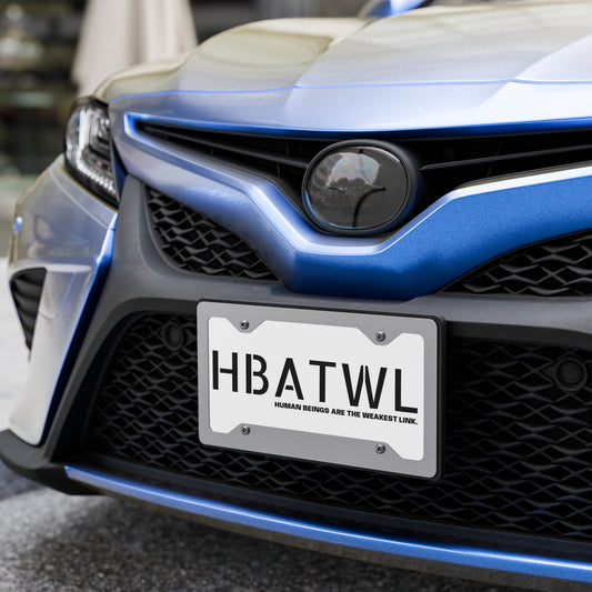 Front facing graphic vanity plate in color white, featuring the initialism 'HBATWL' and the statement 'HUMAN BEINGS ARE THE WEAKEST LINK.' in bold black print, affixed to a car's front grill. From What Was Said (Statement Apparel + More). 