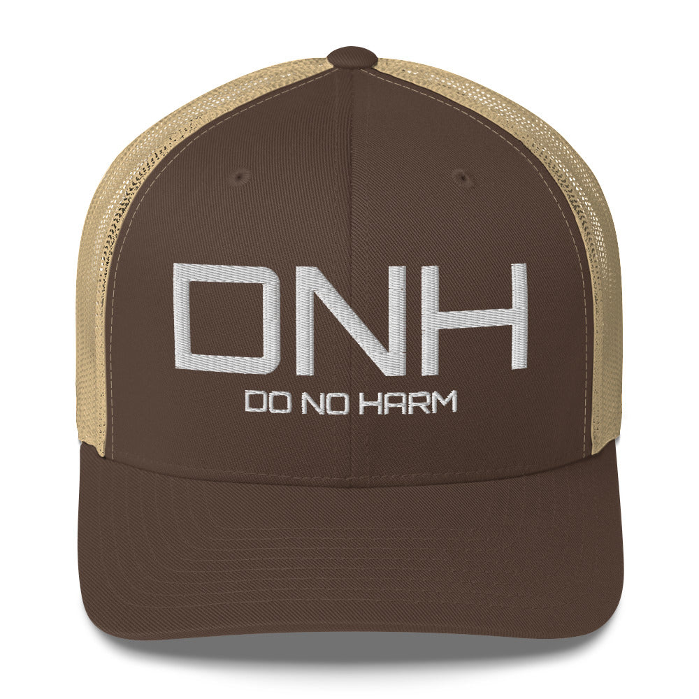 Front facing graphic trucker hat in color brown and khaki, featuring the initialism 'DNH', and the statement 'DO NO HARM,' in bold white embroidery. From What Was Said (Statement Apparel + More).
