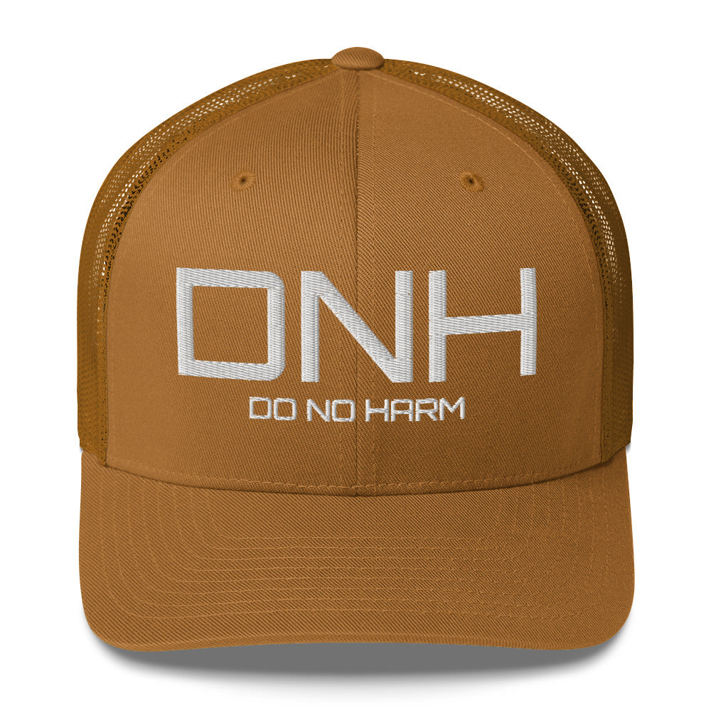 Front facing graphic trucker hat in color caramel, featuring the initialism 'DNH', and the statement 'DO NO HARM,' in bold white embroidery. From What Was Said (Statement Apparel + More).