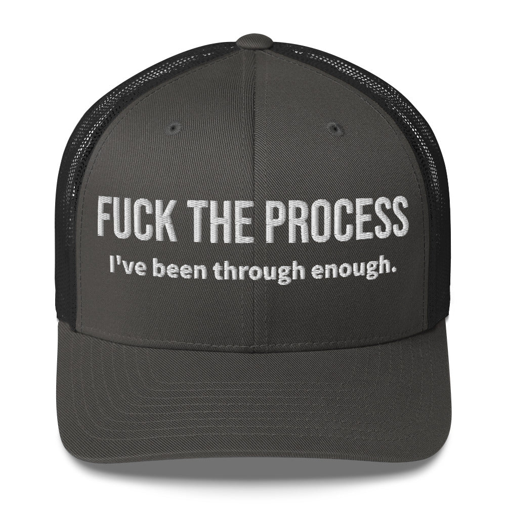 Front facing graphic trucker hat in color charcoal, featuring the statement 'FUCK THE PROCESS, I've Been Through Enough,' in bold white embroidery. From What Was Said (Statement Apparel + More).