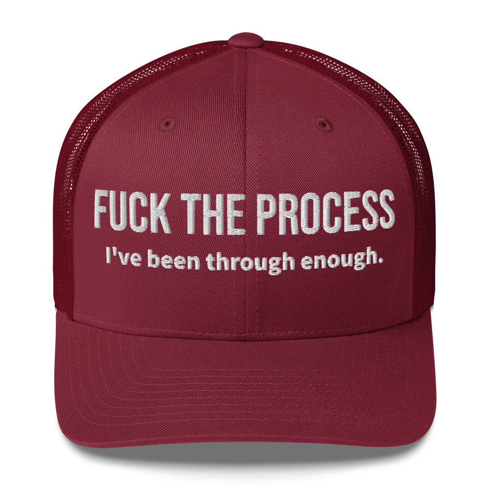 Front facing graphic trucker hat in color cranberry red, featuring the statement 'FUCK THE PROCESS, I've Been Through Enough,' in bold white embroidery. From What Was Said (Statement Apparel + More).