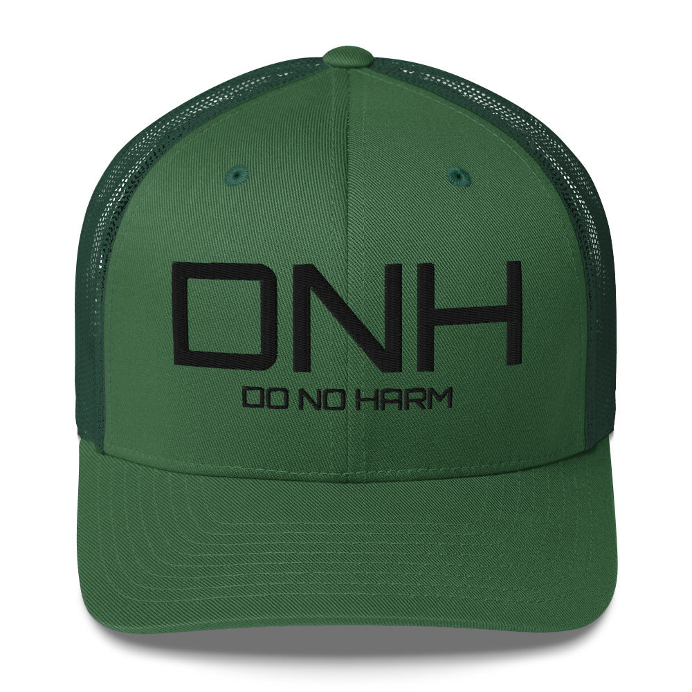 Front facing graphic trucker hat in color evergreen, featuring the initialism 'DNH', and the statement 'DO NO HARM,' in bold black embroidery. From What Was Said (Statement Apparel + More).