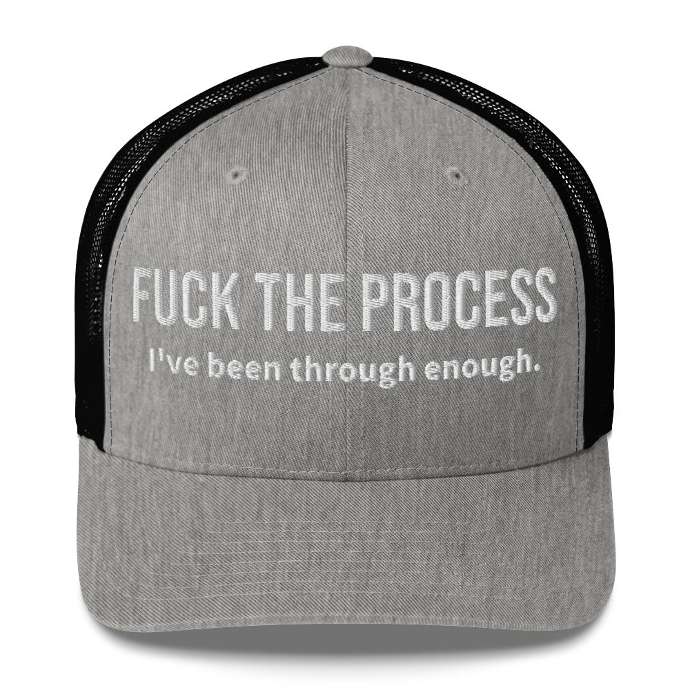 Front facing graphic trucker hat in color heather grey and black, featuring the statement 'FUCK THE PROCESS, I've Been Through Enough,' in bold white embroidery. From What Was Said (Statement Apparel + More).
