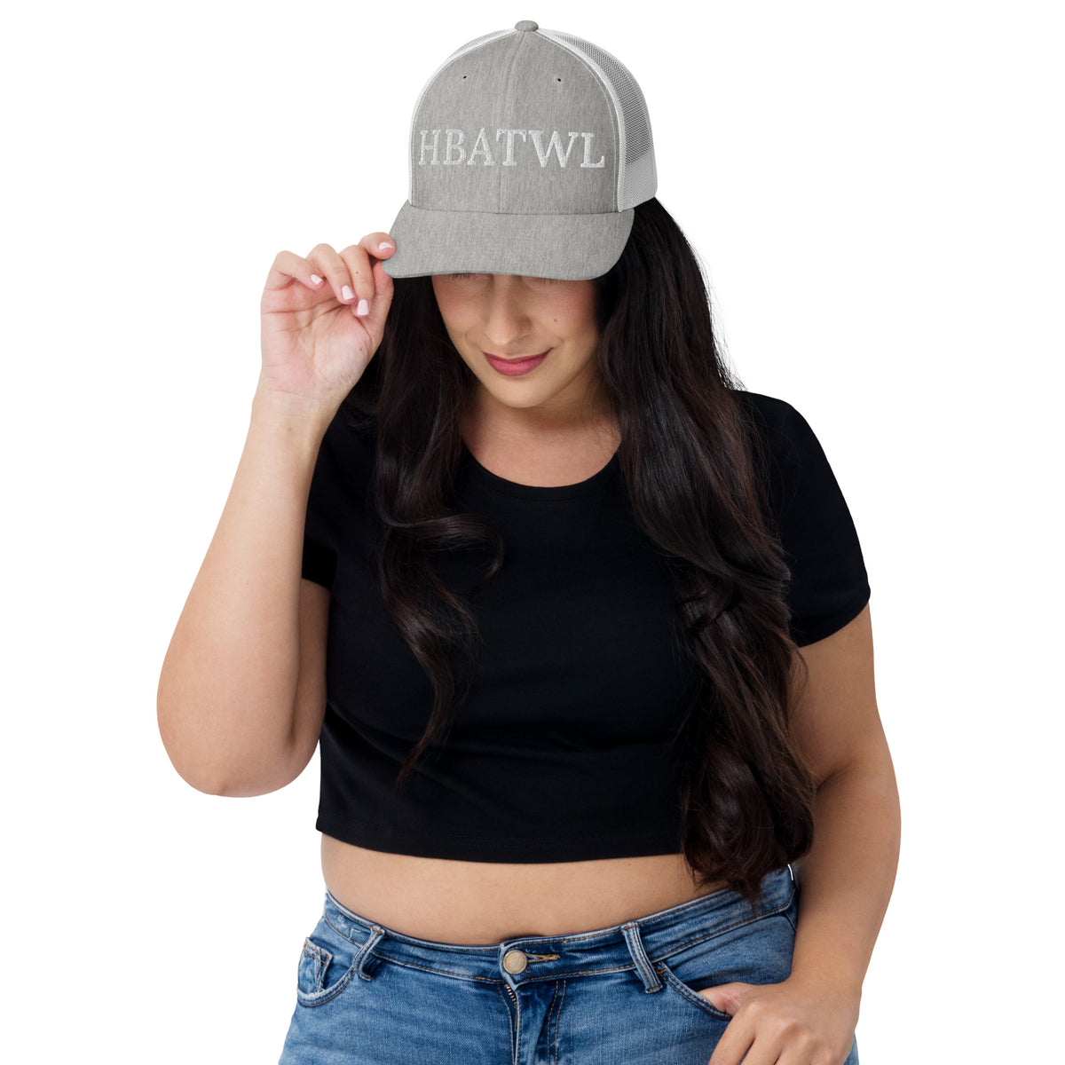 Model is wearing front facing graphic trucker hat in color heather grey and white, featuring the initialism 'HBATWL', from What Was Said (Statement Apparel + More).