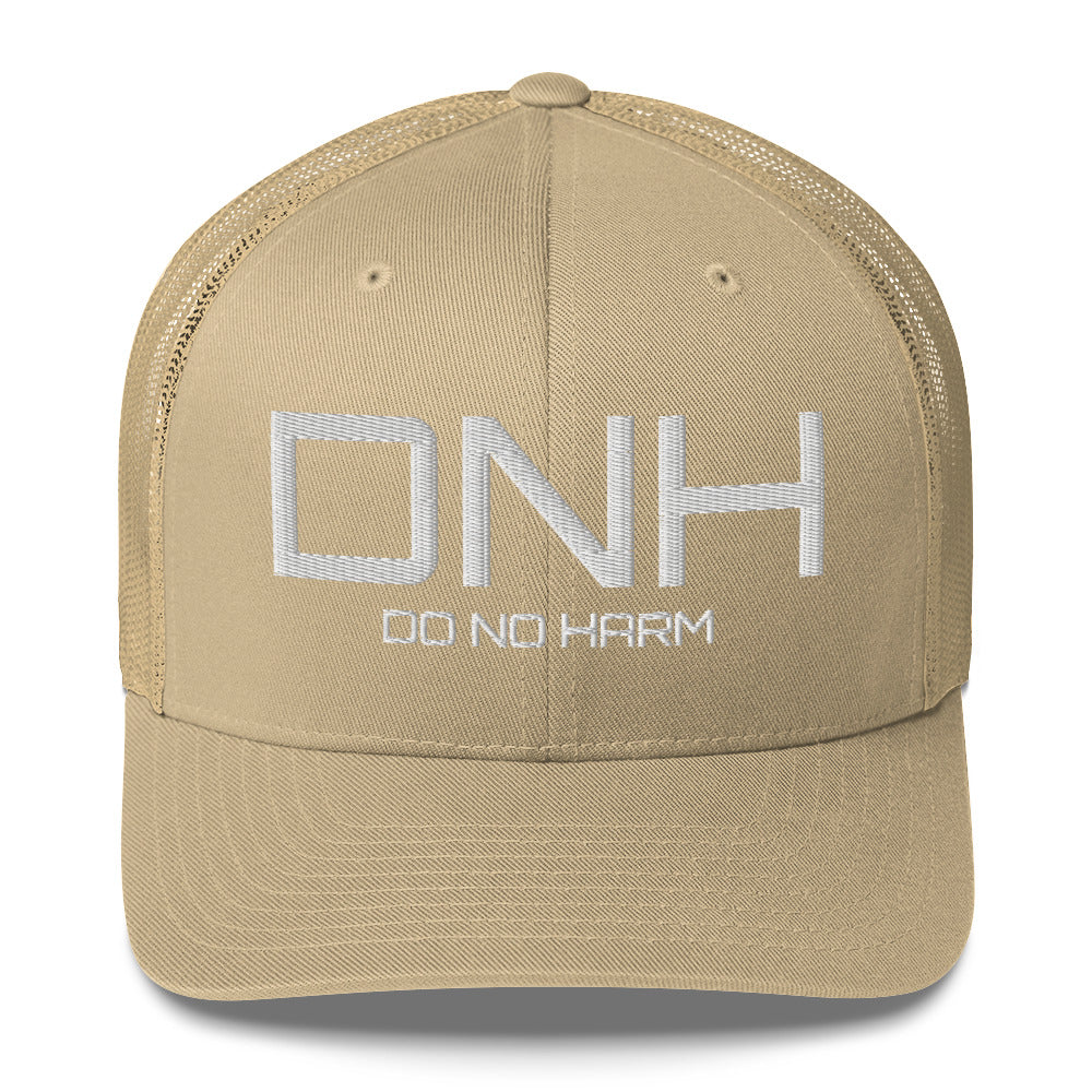 Front facing graphic trucker hat in color khaki, featuring the initialism 'DNH', and the statement 'DO NO HARM,' in bold white embroidery. From What Was Said (Statement Apparel + More).