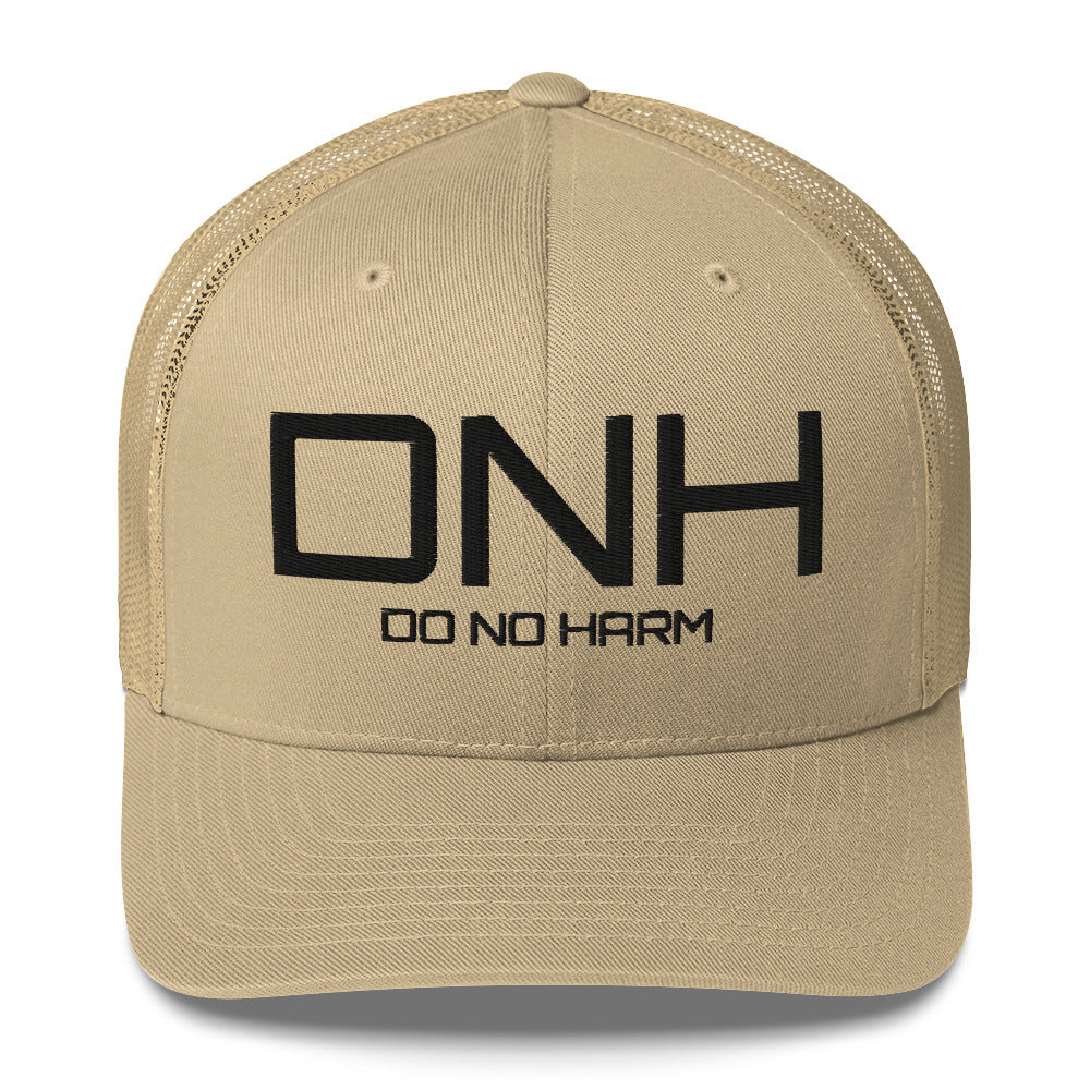Front facing graphic trucker hat in color khaki, featuring the initialism 'DNH', and the statement 'DO NO HARM,' in bold black embroidery. From What Was Said (Statement Apparel + More).