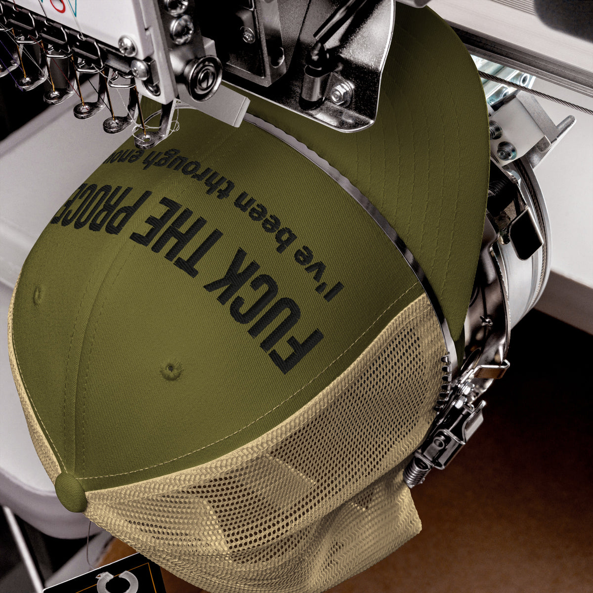 Product detail of embroidered stitching on front facing graphic trucker hat in color moss green and khaki, featuring the statement 'FUCK THE PROCESS, I've Been Through Enough,' in bold black embroidery. From What Was Said (Statement Apparel + More).