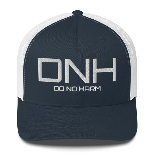 Front facing graphic trucker hat in navy blue and white, featuring the initialism 'DNH', and the statement 'DO NO HARM,' in bold white embroidery. From What Was Said (Statement Apparel + More).